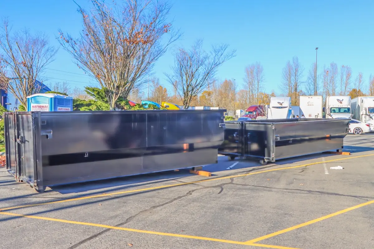 Professional dumpster rental service with roll-off container on residential driveway in Pleasant Hill